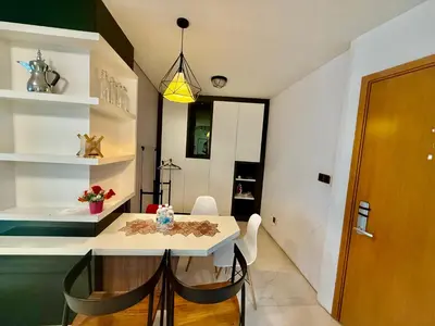 a dining room with a white table and chairs at Vortex Suites Klcc By Bukit Bintang in Kuala Lumpur