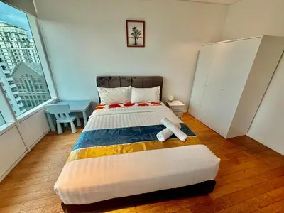 a bedroom with a bed with a teddy bear on it at Vortex Suites Klcc By Bukit Bintang in Kuala Lumpur