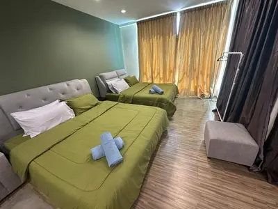 a bedroom with two beds with a blue cross on it at Setapak Central Mall 2 Bed Zetapark Home Sweet Home in Kuala Lumpur