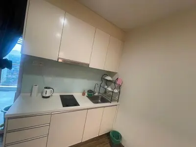 a small kitchen with white cabinets and a sink at Setapak Central Mall 2 Bed Zetapark Home Sweet Home in Kuala Lumpur