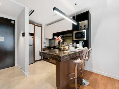 a kitchen with a large island in a room at Leo Guesthouse at Anggun Residence Suite in Kuala Lumpur