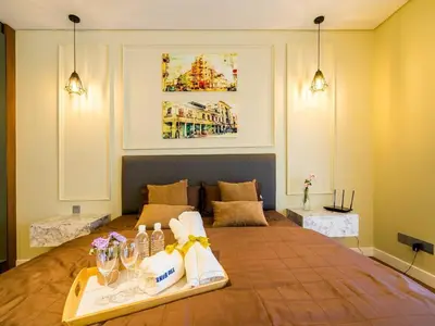 a hotel room with a bed with a tray of towels at Leo Guesthouse at Anggun Residence Suite in Kuala Lumpur