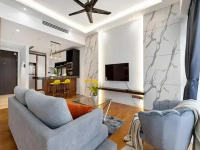 a living room with a couch and a tv at Leo Guesthouse at Anggun Residence Suite in Kuala Lumpur