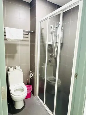 a bathroom with a toilet and a shower at The Mercu Summer Suites By Skyline in Kuala Lumpur