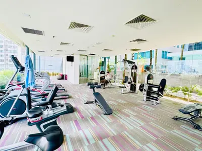 a gym with a bunch of treadmills and exercise bikes at The Mercu Summer Suites By Skyline in Kuala Lumpur