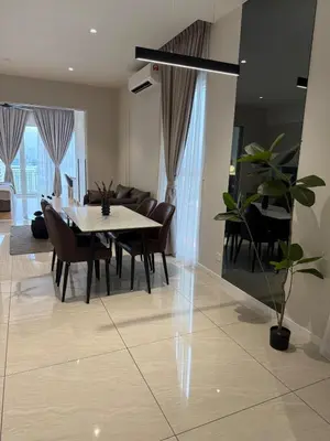 a dining room and living room with a table and chairs at Quill Residence - Sky Glass Condo by Azmila in Kuala Lumpur