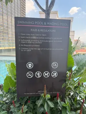a sign for the swimming pool and walking pool at Quill Residence - Sky Glass Condo by Azmila in Kuala Lumpur