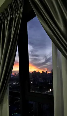 a view of a city skyline from a window at KLCC City View Retreat Cozy Spacious Apartment 2BR 2BTH in Kuala Lumpur