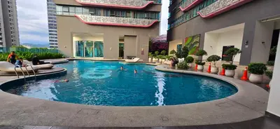 a large swimming pool in the middle of a building at KLCC City View Retreat Cozy Spacious Apartment 2BR 2BTH in Kuala Lumpur