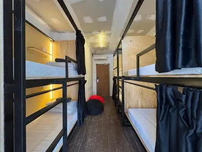 a dorm room with three bunk beds in it at Mingle Lekiu in Kuala Lumpur