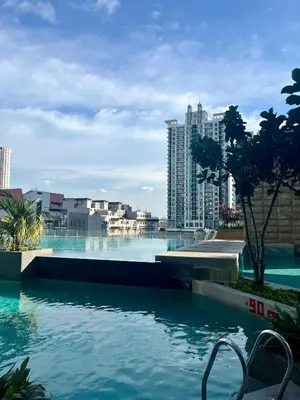a swimming pool with a view of a city at Stay Haven at Swiss Garden in Kuala Lumpur
