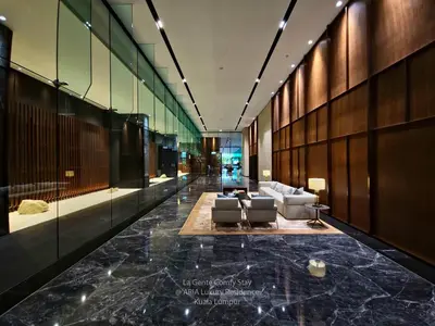 a lobby with a couch and a table in a building at Luxe Spacious 2BR Condo KLCC 600mbps Full Furnish in Kuala Lumpur