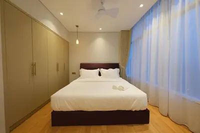 a bedroom with a bed and a large window at 3R2B SkySuites Next to KLCC Twin Tower High Floor in Kuala Lumpur