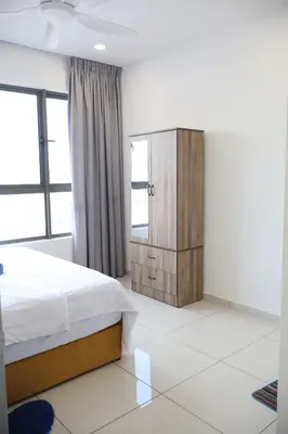 a bedroom with a bed and a wooden cabinet at COZY KenwingstonThe platz Trail 3BR&2BR For 8PAX wifi free Parkin nice view 1902 in Kuala Lumpur