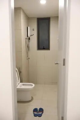 a bathroom with a toilet and two slippers on the floor at COZY KenwingstonThe platz Trail 3BR&2BR For 8PAX wifi free Parkin nice view 1902 in Kuala Lumpur