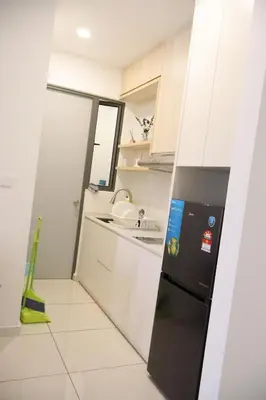 a small kitchen with a black refrigerator and a sink at COZY KenwingstonThe platz Trail 3BR&2BR For 8PAX wifi free Parkin nice view 1902 in Kuala Lumpur