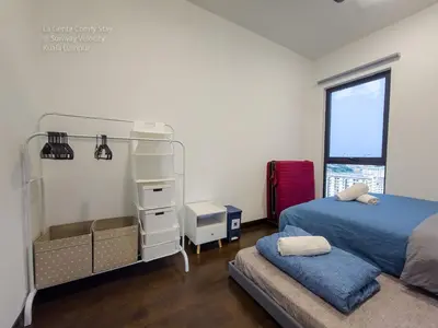 a bedroom with a bed and a window at La Gente Comfy Stay 2R2B Velocity - KL City View in Kuala Lumpur