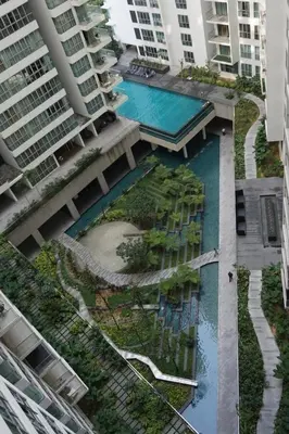 an aerial view of a building with a swimming pool at REGALIA RESIDENCE KLCC VIEW INFINITY POOL by BT RZQNA in Kuala Lumpur