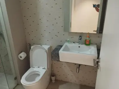 a bathroom with a toilet and a sink at Anggun Residence by Harmony Home in Kuala Lumpur