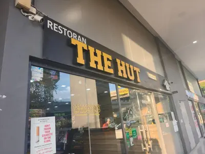 a store front with a sign that reads the hut at M city jalan ampang 5mins to klcc water filter walk to shoplot in Kuala Lumpur