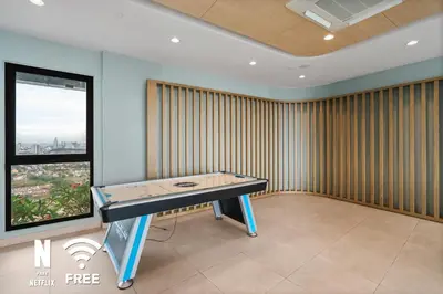 a ping pong table in a room with a window at OOAK 2BR - Mont Kiara Garden international school in Kuala Lumpur