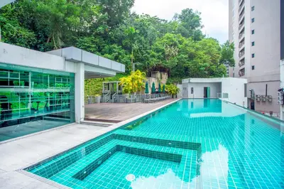 a swimming pool in the middle of a building at Carlton, Chelsea by COBNB, Sri Hartamas, Kuala Lumpur in Kuala Lumpur