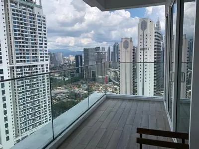 a balcony with a view of a city at Quill Residences Klcc By AB in Kuala Lumpur