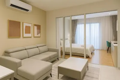 a living room with a couch and a bedroom at Quill Residences Klcc By AB in Kuala Lumpur