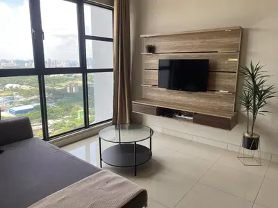 a bedroom with a flat screen tv on a wall at Weekend House Trion in Kuala Lumpur