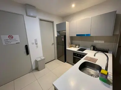 a small kitchen with a sink and a refrigerator at Weekend House Trion in Kuala Lumpur