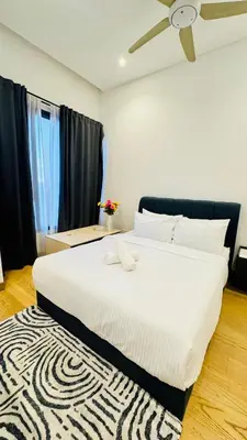 a large white bed in a room with a rug at Luxury Suites Lucentia Residence KLCC at BBCC in Kuala Lumpur
