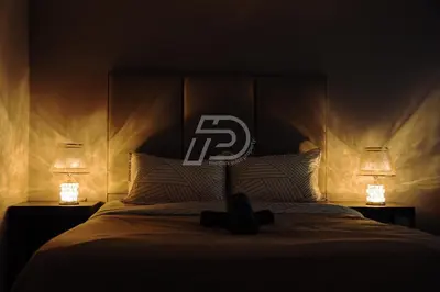 a bedroom with a bed with two lamps on it at Dorsett Hartamas KL, Bathtub Smart TV & WiFi in Kuala Lumpur