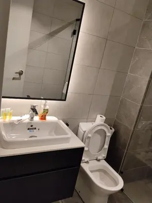a bathroom with a sink and a toilet and a mirror at Axon Suites Bukit Bintang near KLCC by Unitopia in Kuala Lumpur