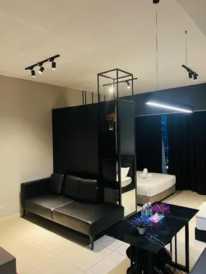 a living room with a couch and a table at Axon Suites Bukit Bintang near KLCC by Unitopia in Kuala Lumpur