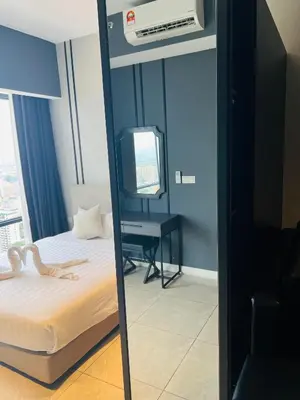 a mirror in a room with a bed and a desk at Axon Suites Bukit Bintang near KLCC by Unitopia in Kuala Lumpur