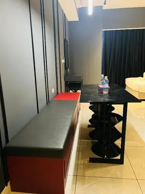 a room with a black counter and a table at Axon Suites Bukit Bintang near KLCC by Unitopia in Kuala Lumpur