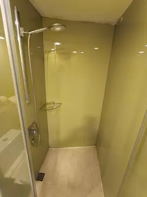 a shower with a glass door in a bathroom at KLCC Sky Villa Suites Vortex in Kuala Lumpur