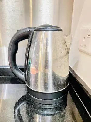 a tea kettle sitting on top of a stove at KLCC Sky Villa Suites The Mews in Kuala Lumpur