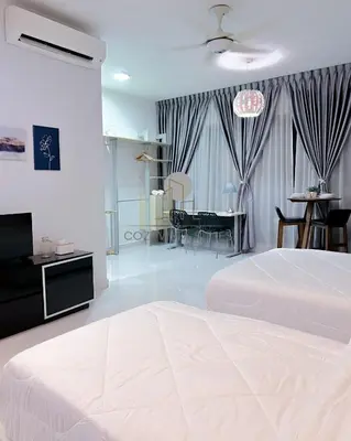 a bedroom with a large white bed and a dining room at Regalia Suites Kuala Lumpur by Cozyvista Suites in Kuala Lumpur