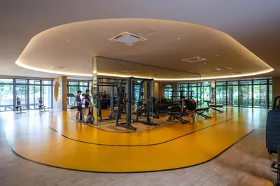a gym with a yellow floor and people in it at M Vertica KL City Residences by Vivid Stay in Kuala Lumpur