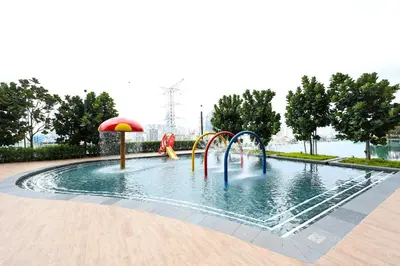 a pool with a water park with slides and an umbrella at M Vertica KL City Residences by Vivid Stay in Kuala Lumpur