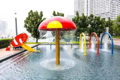 a water park with a playground with an umbrella at M Vertica KL City Residences by Vivid Stay in Kuala Lumpur