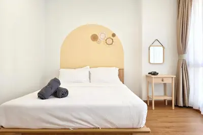 a bedroom with a large white bed with an arch at Bintang Fairlane Bukit Bintang #121 near Pavilion KLCC Kuala Lumpur in Kuala Lumpur