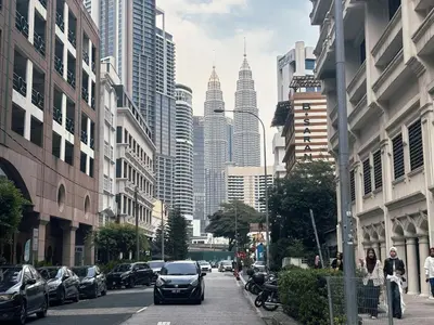 a city street with cars driving down a street with tall buildings at KLCC Bukit Bintang Anggun Residence 5min walk to Monorail station in Kuala Lumpur