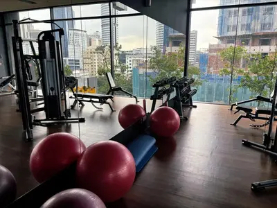 a gym with exercise equipment and a large window at KLCC Bukit Bintang Anggun Residence 5min walk to Monorail station in Kuala Lumpur