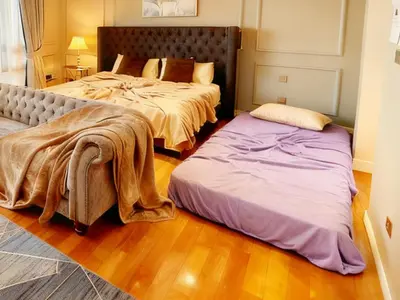 a bedroom with two beds and a bedskirts at KLCC Bukit Bintang Anggun Residence 5min walk to Monorail station in Kuala Lumpur