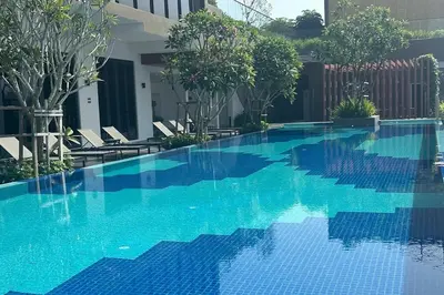 a swimming pool with blue water in a building at Majestic Residence KLCC By Flixhome in Kuala Lumpur
