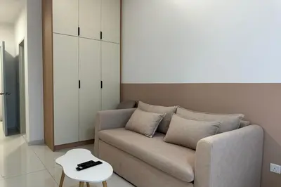 a living room with a couch and a table at Majestic Residence KLCC By Flixhome in Kuala Lumpur
