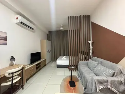 a living room with a couch and a bed at Majestic Residence KLCC By Flixhome in Kuala Lumpur
