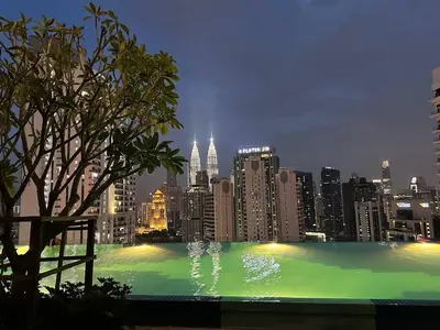a view of a city skyline at night at Majestic Residence KLCC By Flixhome in Kuala Lumpur